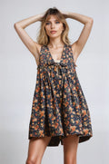 Woman wearing a floral dress against a plain background