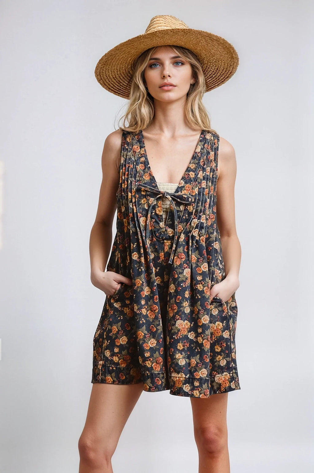 Woman wearing a floral dress and straw hat on a white background