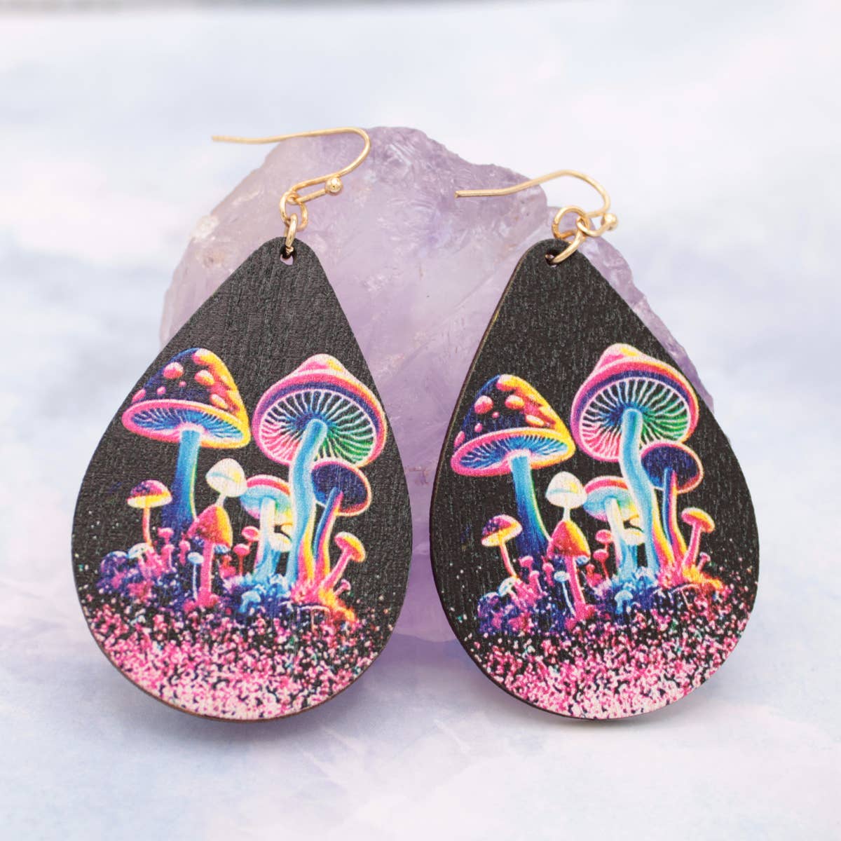 Teardrop-shaped earrings with colorful mushroom design on a light gray background