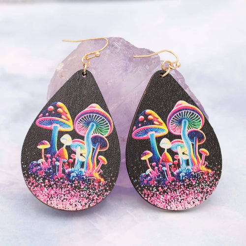 Teardrop-shaped earrings with colorful mushroom design on a light gray background